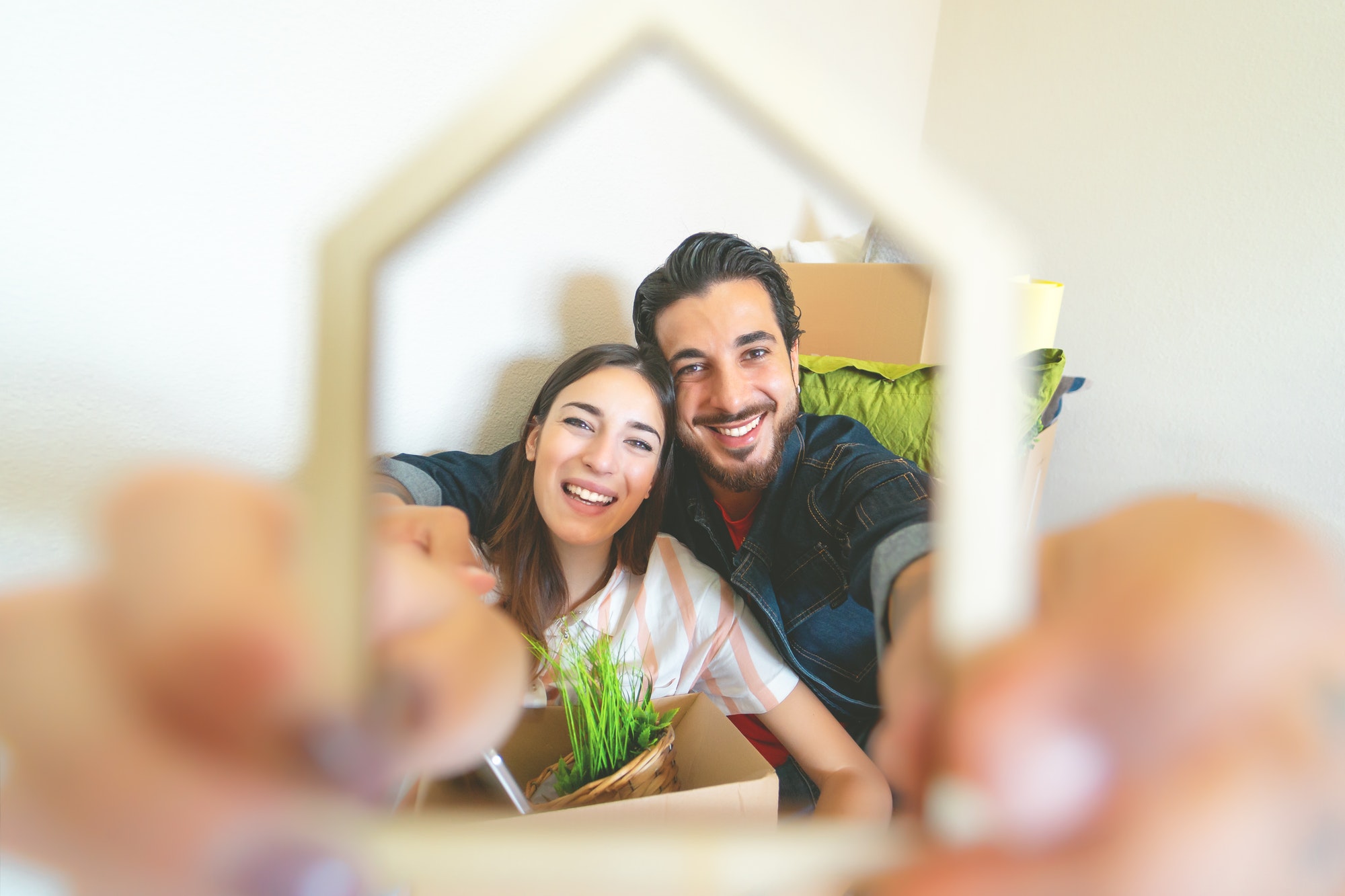Happy young couple moving in new home first time